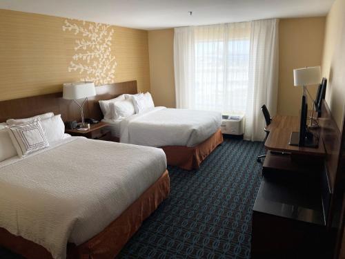 a hotel room with two beds and a television at Fairfield Inn & Suites by Marriott East Grand Forks in East Grand Forks