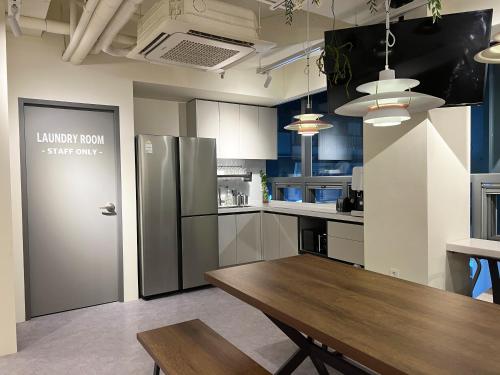 a kitchen with a wooden table and a refrigerator at Seoul Cube Jongro in Seoul