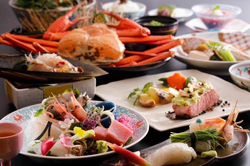 a table with many plates of food on it at Kaikatei Hanagozen in Kyotango