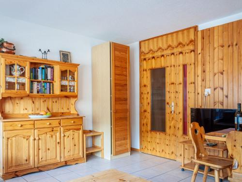 a dining room with a table and a wooden wall at Apartment Christiania 2 B7 by Interhome in Nendaz