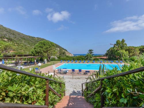 a view of a swimming pool with a resort at Apartment Altaluna-5 by Interhome in Nisporto