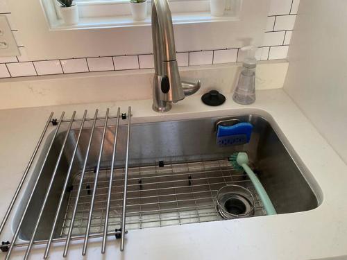 a kitchen sink with a dish washer in it at Modern Home Near Uptown CLT, Airport and More in Charlotte