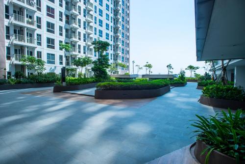 a courtyard in a building with plants and buildings at Tokyo Riverside Apartment @ PIK 2 in Tangerang