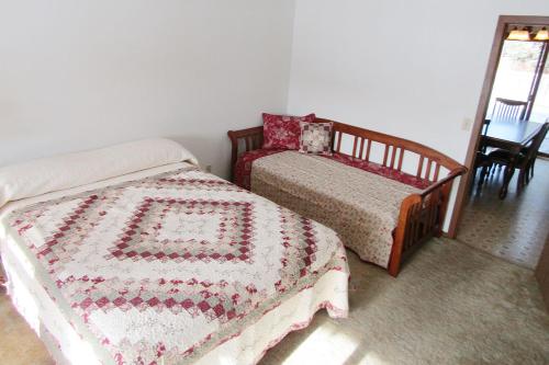 a bedroom with two twin beds and a table at Freedom Ridge Cabins in Hill City
