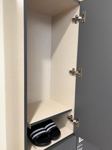 a closet with two pairs of shoes in it at Seoul Cube Jongro in Seoul