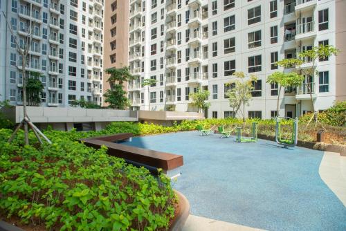 a courtyard in a city with tall buildings at Tokyo Riverside Apartment @ PIK 2 in Tangerang