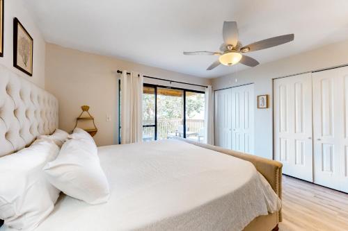 a bedroom with a white bed and a ceiling fan at Portside Resort E2 in Panama City Beach