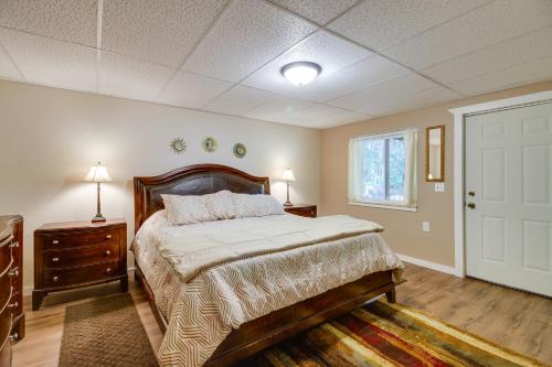 a bedroom with a bed and a window and a door at White Swan Lake Home with Decks and Private Beach! in Bigfork