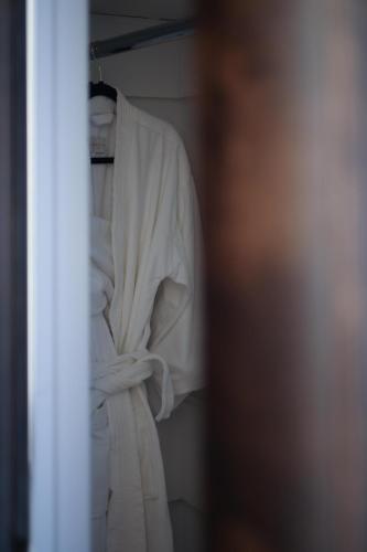 a white dress is hanging on a rack at Fairmount Hotel, in the Unbound Collection by Hyatt in San Antonio