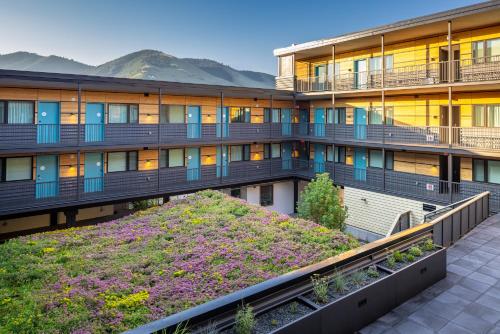 an apartment building with a garden in front of it at The Wren in Missoula