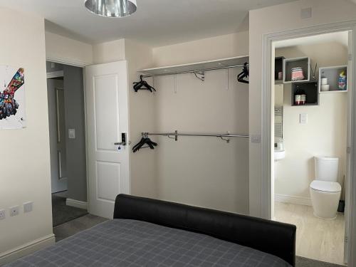 a bedroom with a bed and a door with a closet at Home from home midlands in Glascote