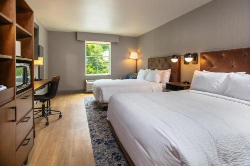 a hotel room with two beds and a television at Four Points by Sheraton Deadwood in Deadwood