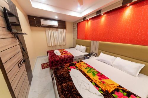 a hotel room with two beds at Hotel Signature Near Sea Beach #NewDigha in Digha