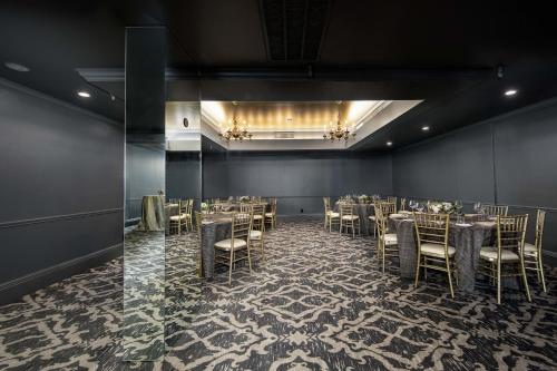 a dining room with tables and chairs in it at Fairmount Hotel, in the Unbound Collection by Hyatt in San Antonio