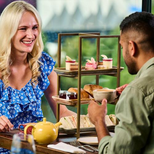 a woman sitting at a table with a man at Genting Hotel & Spa at Resorts World Birmingham in Bickenhill