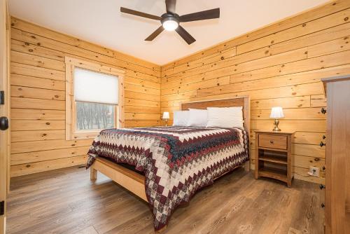 a bedroom with a bed and a ceiling fan at Johns Place in McHenry