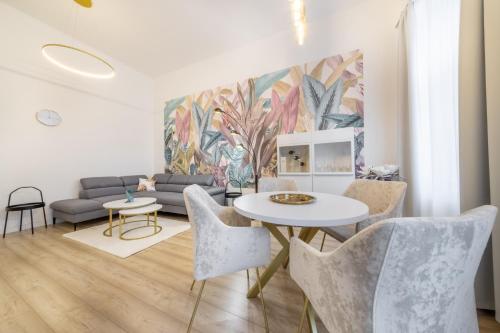 a living room with a couch and a table and chairs at Souper Apartments Downtown-Király Street in Budapest