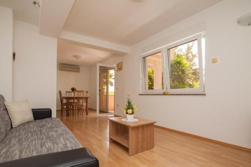a living room with a couch and a table at Apartment Juliette in Zadar