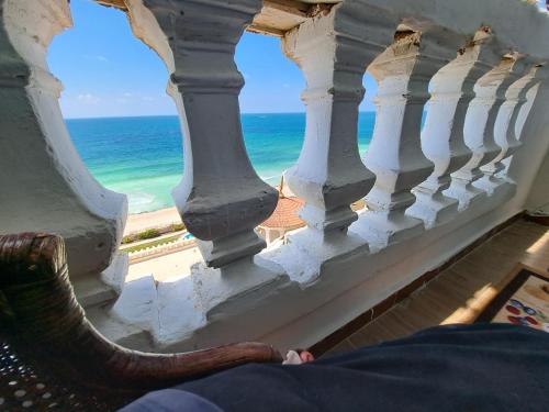 an elephant sitting on a balcony looking out at the ocean at Panorama Apartment with a charming sea view near Alexandria and Burg ElArab Airport with Free Wifi شقة باطلالة ساحرة على البحر اول الساحل الشمالي واي فاي مجاني迷人海景公寓 免费无线网络 in Alexandria