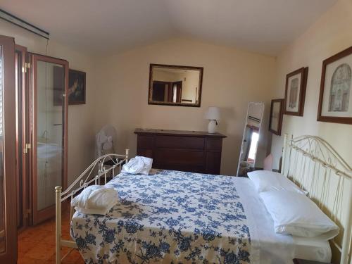 a bedroom with a bed with a blue and white blanket at Al comune in Atri