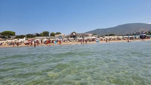 a beach with a bunch of people in the water at LA VILLA fronte SPIAGGIA BANDIERA BLU in Sperlonga