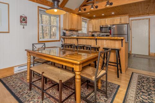 a kitchen with a wooden table and chairs at Chasing Dreams in Swanton