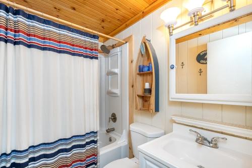 a bathroom with a sink and a toilet and a mirror at Chasing Dreams in Swanton