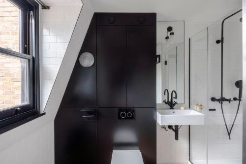 a bathroom with a sink and a toilet and a shower at The Instagood Apartment - Covent Garden - by Frankie Says in London