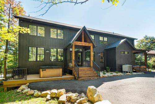 a home with a black house with a front porch at No Black Tie Affair in McHenry