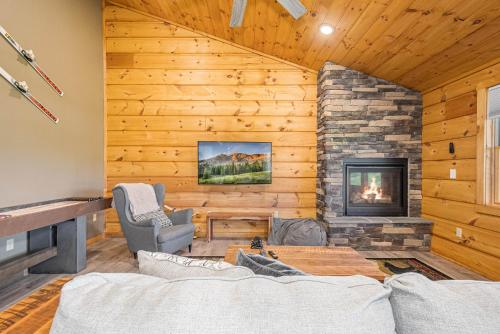 a living room with a fireplace and a stone wall at Base Camp in McHenry