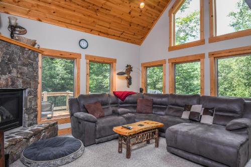 a living room with a couch and a fireplace at Canopy Escape in McHenry