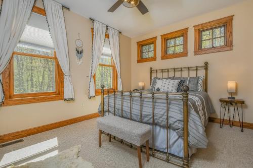 a bedroom with a bed and a chair and windows at Winding Down Slope Side in Oakland