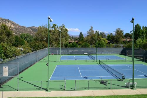 a tennis court with two tennis courts at Riviera Oaks Resort in Ramona