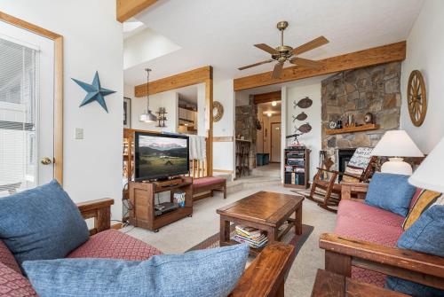 a living room with a couch and a tv at Ski Harbor 14 in McHenry