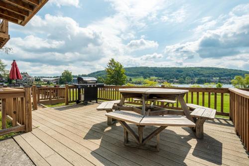 a wooden deck with a picnic table and a grill at Ski Harbor 14 in McHenry