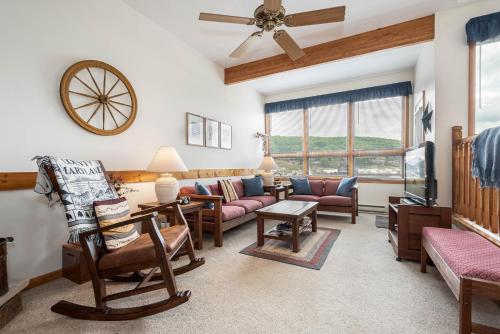 a living room with furniture and a ceiling fan at Ski Harbor 14 in McHenry