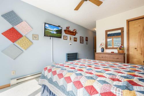 a bedroom with a bed and a tv on a wall at Ski Harbor 14 in McHenry