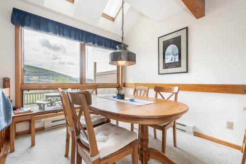 a dining room with a table and chairs and a window at Ski Harbor 14 in McHenry