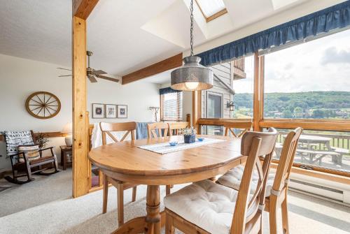 a dining room with a table and chairs and a large window at Ski Harbor 14 in McHenry