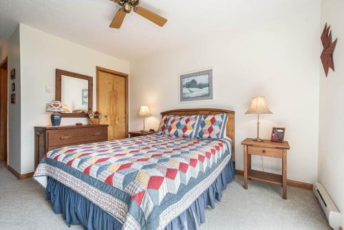 a bedroom with a bed and a ceiling fan at Ski Harbor 14 in McHenry