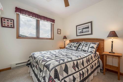 a bedroom with a bed and a window at Ski Harbor 14 in McHenry