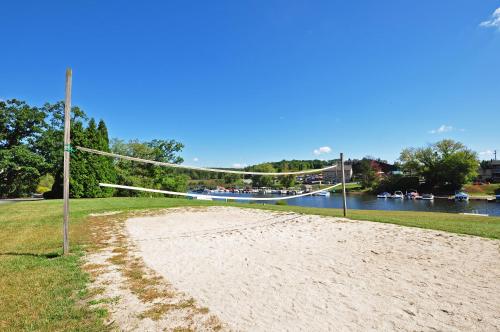 a volleyball net on a beach next to a river at Ski Harbor 14 in McHenry