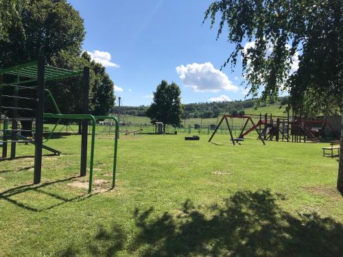 a park with a playground with a swing set at Prázdninový dům na Pálavě s vinným sklepem in Milovice