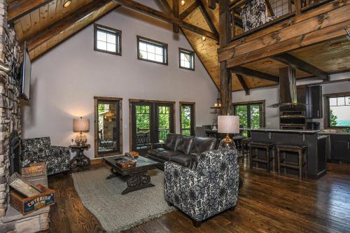 a living room with leather furniture and a fireplace at Above it All in McHenry