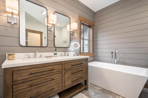 a bathroom with a tub and a sink and mirror at Dreidels Den in McHenry