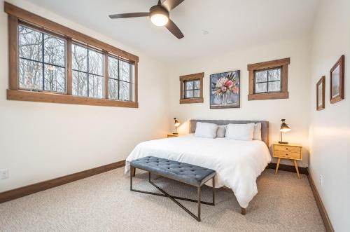 a bedroom with a bed and a ceiling fan at Dreidels Den in McHenry