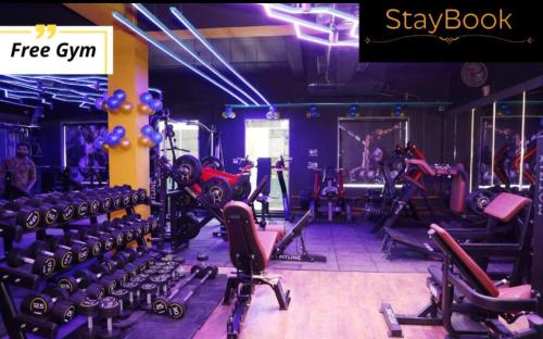 a gym with a bunch of tread machines in it at Staybook Hotel Aira, Paharganj, New Delhi Railway Station in New Delhi