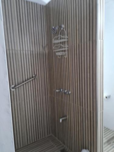 a glass shower door with a bird cage on it at Sky Beach Rooms in Hopewell