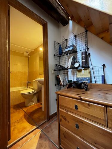 a bathroom with a wooden dresser and a toilet at Latina in Madrid