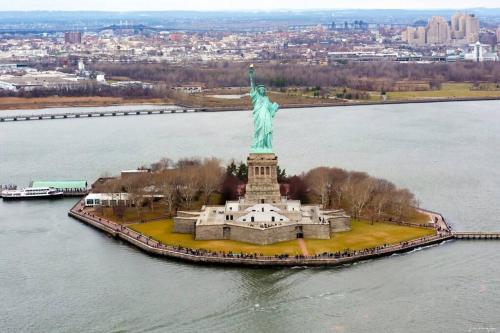 an aerial view of the statue of liberty in the water at SWJ 2nd - Times SQ, Brooklyn Bridge, LGA in 15 min in New York